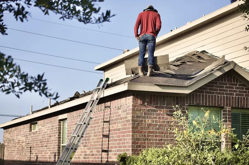 Professional roofer working on a residential roof in Boulevard